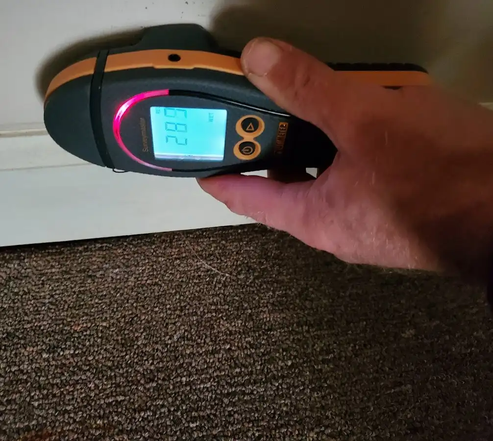 Moisture detection at baseboard during Storm Damage Restoration in Greendale
